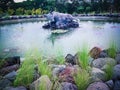 Sweet View Of The Pond With Sleeping Bull Statue In The Middle In The Park