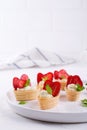 Sweet waffle basket with cream cheese and strawberries for summer breakfast over white Royalty Free Stock Photo