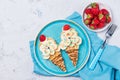 Sweet waffles with banana and strawberry in a shape of ice cream cone, meal for kids idea, top view Royalty Free Stock Photo