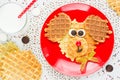 Sweet waffles with chocolate and milk for baby breakfast. Creative idea for children fun dessert or breakfast - puppy dog shaped