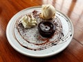 Sweet warm chocolate lava cake with vanilla ice cream and whipping cream on a white plate Royalty Free Stock Photo