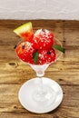 Sweet watermelon ice cream with coconut flakes and fresh basil leaves Royalty Free Stock Photo