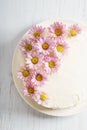 Sweet white buttercream cake with pink flowers on top