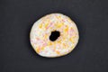 Sweet white donut on dark background. Dessert food.