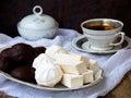 Sweet white Russian marshmallow, chocolate zephyr, meringue, apple pastila and cup of coffee on wooden background. Royalty Free Stock Photo