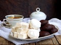 Sweet white Russian marshmallow, chocolate zephyr, meringue, apple pastila and cup of coffee on wooden background. Royalty Free Stock Photo