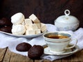 Sweet white Russian marshmallow, chocolate zephyr, meringue, apple pastila and cup of coffee on wooden background. Royalty Free Stock Photo