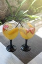 Sweet white sangria fruit in glass goblets on the table. Traditional spanish food. Two glasses on a table in a Spanish restaurant Royalty Free Stock Photo