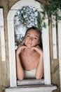 Sweet woman leaning on a decor window construction