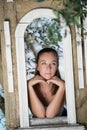 Sweet woman leaning on a decor window construction