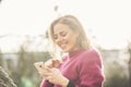 Sweet woman in the park using her cell phone