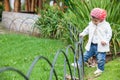 Sweet year and a half baby girl at the garden in a beautiful sunny day