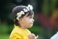 Sweet year and a half baby girl at the garden in a beautiful sunny day