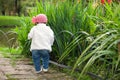 Sweet year and a half baby girl at the garden in a beautiful sunny day