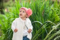 Sweet year and a half baby girl at the garden in a beautiful sunny day