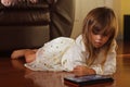 Sweet 4 year old girl in white, playing with iPad