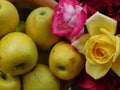 Sweet yellow apples and bouquet of roses