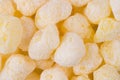 Sweet yellow corn sticks with powdered sugar texture, background, top view. Royalty Free Stock Photo
