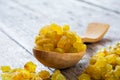 Sweet yellow raisins in a wooden spoon on a wooden table Royalty Free Stock Photo