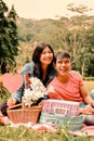 a sweet young asian couple having a picnic in the park like a lovers