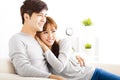 Sweet young couple sitting in sofa
