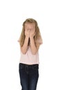 Sweet young little schoolgirl covering her face with her hands crying sad victim of bullying at school Royalty Free Stock Photo