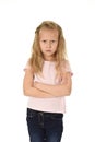 Sweet young schoolgirl with blond hair and folded arms angry upset frustrated and unhappy