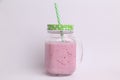 Sweet and yummy strawberry smoothie in the glass jar with a straw Royalty Free Stock Photo