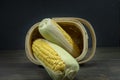 Sweetcorn cobs spilling out of tipped wicker basket