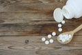 Sweetener, stevia in tablets in wooden spoon on table Royalty Free Stock Photo