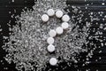 Sweetener tablets lying with sugar on a dark background