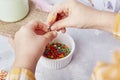 Sweetness of Easter traditions as children add sprinkles to decorate cookies close up