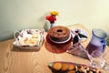 Sweets, cake, bread, juice, flowers and glass cups on a table