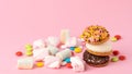 Sweets - cake, sweets, dragees, marshmallows on a pink background