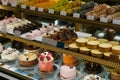 Sweets and cakes on display in bakery shop