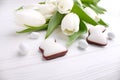 Sweets for celebrate Easter. White tulips, chocolate eggs Royalty Free Stock Photo
