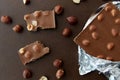 Milk chocolate bar with hazelnuts in foil wrapper Royalty Free Stock Photo