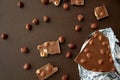 Milk chocolate bar with hazelnuts in foil wrapper Royalty Free Stock Photo