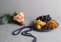 Sweets, dates, dried apricots on a plate. Flower.