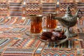 Sweets, dates and tea on a carpet