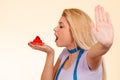 Woman with measuring tape holding cupcake showing stop Royalty Free Stock Photo