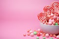 Sweets, lollipop, and candy canes on pink background, tempting treats