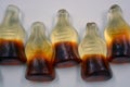 Bright children\'s chewing, jelly sweets in the form of drinks, bottles of cola are located on a white background.