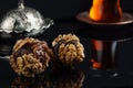 Sweets with nuts next to a cup of tea Royalty Free Stock Photo