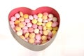 Sweets in an open silver heart shaped box