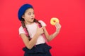 Sweets shop and bakery concept. Kids huge fans of baked donuts. Impossible to resist fresh made donut. Girl hold glazed Royalty Free Stock Photo