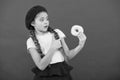 Sweets shop and bakery concept. Kids huge fans of baked donuts. Impossible to resist fresh made donut. Girl hold glazed Royalty Free Stock Photo