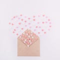 Sweets sugar candy hearts fly out in the form of heart from craft paper envelope on the white background . Valentine day concept. Royalty Free Stock Photo