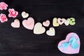 Sweets on Valentine`s Day. Cookies in shape of heart and with lettering Love on dark wooden background top view copy Royalty Free Stock Photo