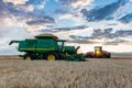 Swift Current, SK/Canada- Aug 25, 2019: Sunburst over combine at harvest